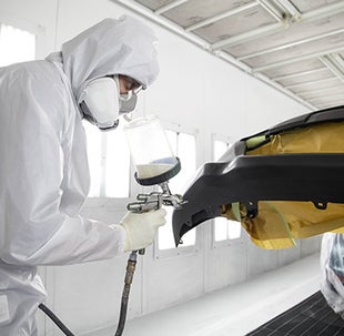 Collision Center Technician Painting a Vehicle | Great Lakes Toyota in Findlay OH