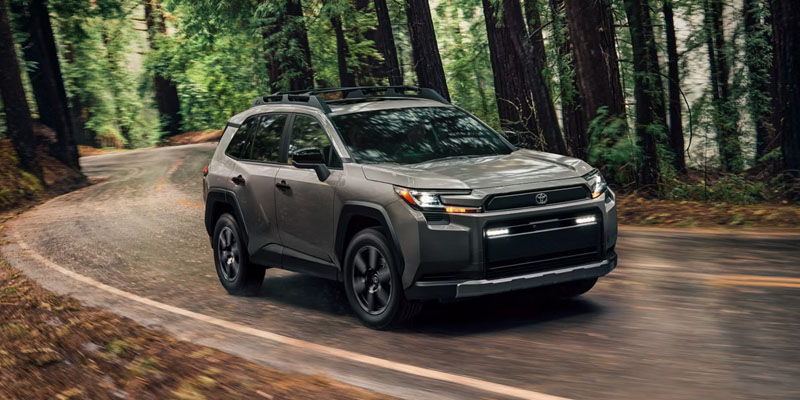 2026 Toyota RAV4 SUV driving forest road